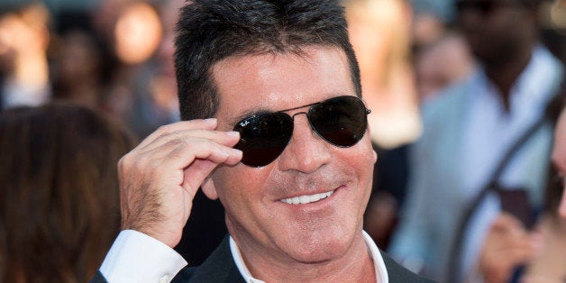 LONDON, ENGLAND - AUGUST 20: Simon Cowell attends the World Premiere of 'One Direction: This Is Us' at Empire Leicester Squa