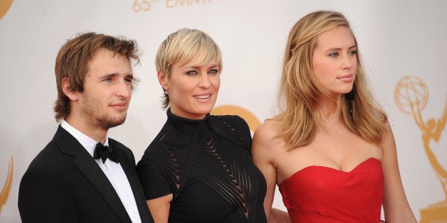 Actress Robin Wright arrives with daughter Dylan (R) and son Hopper (L) on the red carpet for the 65th Emmy Awards in Los Angeles on September 22, 2013. AFP PHOTO / Robyn Beck (Photo credit should read ROBYN BECK/AFP/Getty Images)