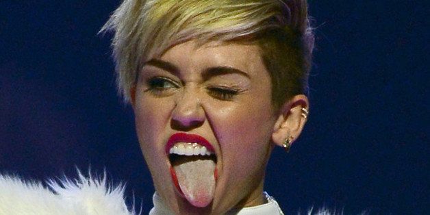 LAS VEGAS, NV - SEPTEMBER 21: Entertainer Miley Cyrus winks and sticks out her tongue as she performs during the iHeartRadio Music Festival at the MGM Grand Garden Arena on September 21, 2013 in Las Vegas, Nevada. (Photo by Ethan Miller/Getty Images for Clear Channel)