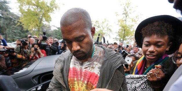 US musician Kanye West signs autographs after Celine 2014 Spring/Summer ready-to-wear collection fashion show, on September 2