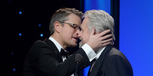 BEVERLY HILLS, CA - JANUARY 14: United Nations Messenger of Peace Michael Douglas (R) accepts the Danny Kaye Humanitarian Peace Award onstage from Matt Damon during the 2014 UNICEF Ball presented by Baccarat at the Beverly Wilshire Four Seasons Hotel on January 14, 2014 in Beverly Hills, California. (Photo by Michael Buckner/Getty Images for UNICEF)