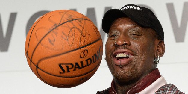 Former NBA star Dennis Rodman plays with a basketball during a press conference in Tokyo on October 25, 2013. Rodman is here to promote NBA ahead of the season opening games on October 30. AFP PHOTO/Toru YAMANAKA (Photo credit should read TORU YAMANAKA/AFP/Getty Images)
