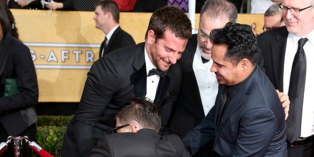 LOS ANGELES, CA - JANUARY 18: Bradley Cooper, Michael Pena (R) and Vitalii Sediuk (bottom) arrive at the 20th Annual Screen Actors Guild Awards at the Shrine Auditorium on January 18, 2014 in Los Angeles, California. (Photo by Dan MacMedan/WireImage)