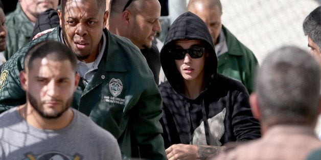 MIAMI, FL - JANUARY 23: Justin Bieber (R) exits from the Turner Guilford Knight Correctional Center on January 23, 2014 in Miami, Florida. Justin Bieber was charged with drunken driving, resisting arrest and driving without a valid license after Miami Beach police found the pop star street racing Thursday morning. (Photo by Joe Raedle/Getty Images)