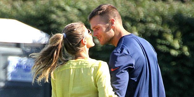 FOXBOROUGH, MA - AUGUST 15: Tom Brady walks with his wife, Gisele Bundchen, and their sons, Benjamin, left, and Jack, partially hidden, as the New England Patriots end their last practice on Thursday, August 15, 2013, before the Friday exhibition game against the Tampa Bay Buccaneers. (Pat Greenhouse/The Boston Globe via Getty Images)
