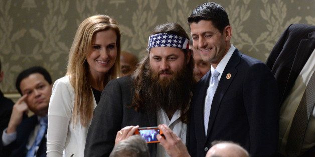 Willie Robertson (C) of the television show Duck Dynasty poses for a picture with US Repubklican Representative from Wisconsin Paul Ryan (R) and his wife Janna Ryan before US President Barack Obama delivers his State of the Union address before a joint session of Congress on January 28, 2014 at the US Capitol in Washington. AFP PHOTO/Jewel Samad (Photo credit should read JEWEL SAMAD/AFP/Getty Images)