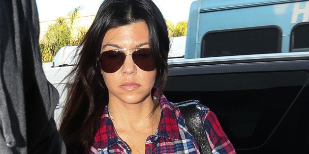 LOS ANGELES, CA - DECEMBER 01: Kourtney Kardashian and Scott Disick are seen arriving at LAX airport on December 01, 2013 in