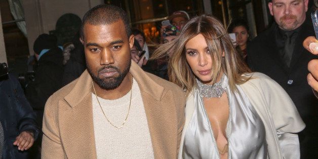 PARIS, FRANCE - JANUARY 21: Kanye West and Kim Kardashian leave the 'Meurice' hotel on January 21, 2014 in Paris, France. (Photo by Marc Piasecki/FilmMagic)