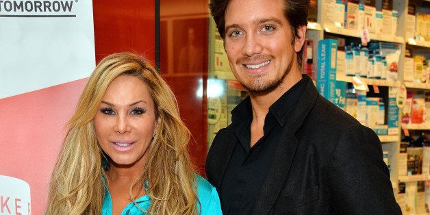 LOS ANGELES, CA - FEBRUARY 27: Television personality Adrienne Maloof (L) and her boyfriend Jacob Busch appear at GNC Beverly Center to promote 'Never Hungover' elixir at GNC at The Beverly Center on February 27, 2014 in Los Angeles, California. (Photo by Amanda Edwards/Getty Images)