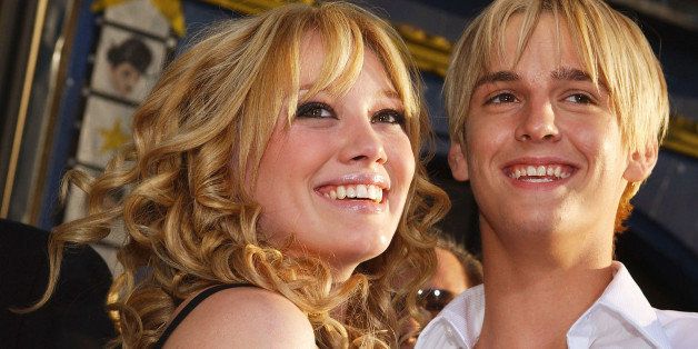 HOLLYWOOD, CA - APRIL 26: Actress Hilary Duff (L) hugs singer Aaron Carter as they attend the premiere of The Lizzie McGuire Movie on April 26, 2003 in Hollywood, California. (Photo by Lucy Nicholson/Getty Images)
