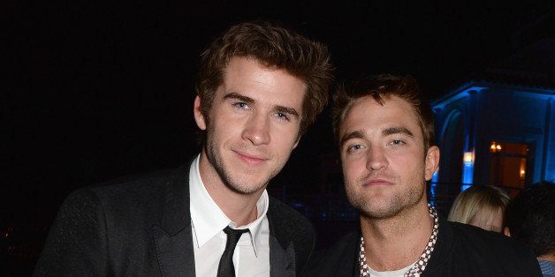 CAP D'ANTIBES, FRANCE - MAY 17: (L-R) Liam Hemsworth and Robert Pattinson attend the Vanity Fair And Armani Party at the 67th Annual Cannes Film Festival on May 17, 2014 in Cap d'Antibes, France. (Photo by Dave M. Benett/VF14/WireImage)