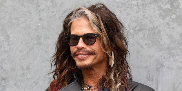US rockstar Steven Tyler, singer of the Aerosmith group poses at his arrival to attend the Emporio Armani men's Spring-Summer 2015 show, part of the Milan Fashion Week, unveiled in Milan, Italy, Monday, June 23, 2014. (AP Photo/Luca Bruno)