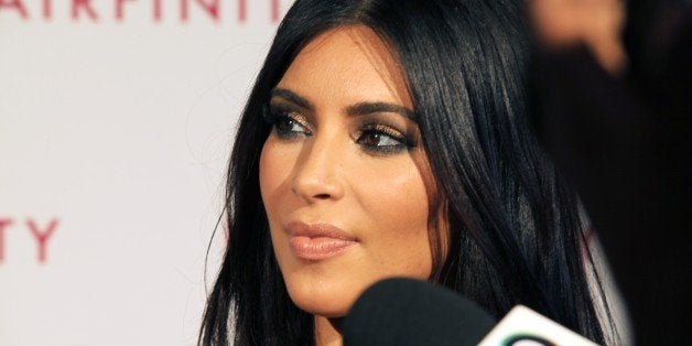 Kim Kardashian talks to the media on her arrival at the Hairfinity party in central London, Saturday, Nov. 8, 2014. (Photo by Grant Pollard/Invision/AP)