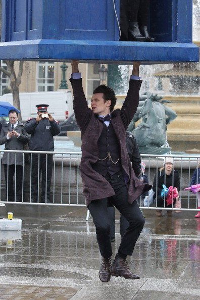 LONDON, ENGLAND - APRIL 09: Matt Smith stands beneath a suspended Tardis during filming of Dr Who, in Trafalgar Square on April 9, 2013 in London, England. (Photo by Neil P. Mockford/FilmMagic)