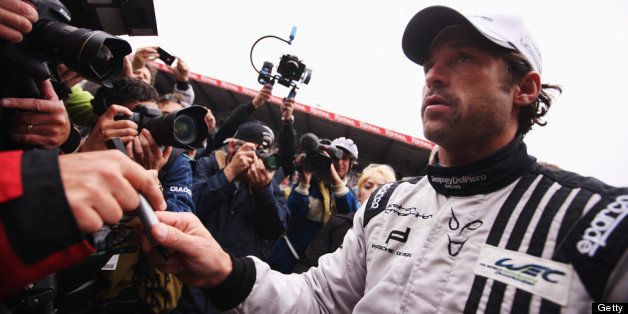 LE MANS, FRANCE - JUNE 22: Actor Patrick Dempsey of the Dempsey Del Piero-Proton team is surrounded by media and well wishers on the grid before the Le Mans 24 Hour race at the Circuit de la Sarthe on June 22, 2013 in Le Mans, France. (Photo by Ker Robertson/Getty Images)