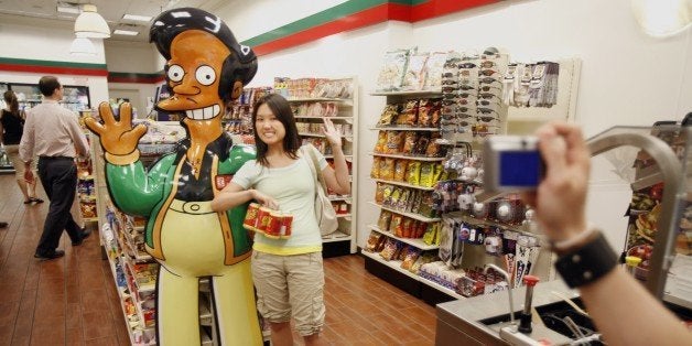 NEW YORK - JULY 2: Mandy Lui (C) of Toronto poses with larger than life 'Apu' from the television cartoon show 'The Simpsons' at a 7-11 store on 345 W. 42nd Street, converted into a Kwik-E-Mart to promote 'The Simpsons Movie' opening next month, July 2, 2007 in New York City. The fictional Kwik-E-Mart is selling products from the cartoon -- like, KrustyO's cereal, Buzz Cola, and Squishees. (Photo by Michael Nagle/Getty Images)