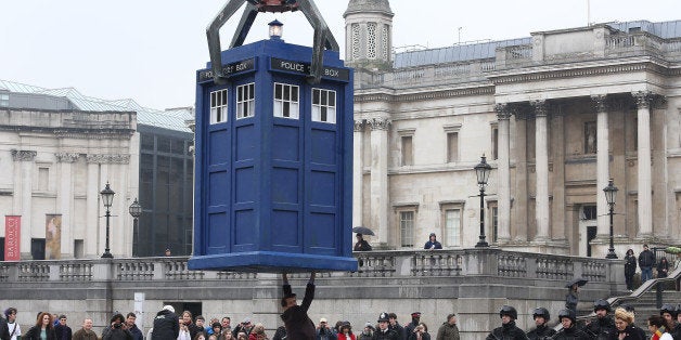 LONDON, ENGLAND - APRIL 09: Matt Smith stands beneath a suspended Tardis during filming of Dr Who, in Trafalgar Square on Ap