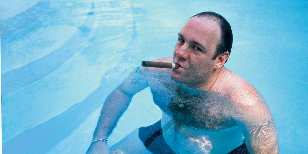 American actor James Gandolfini, as Tony Soprano, smokes a cigar while he stands in pool, in publicity still for the HBO cable TV series 'The Sopranos,' 1999. (Photo by Anthony Neste//Time Life Pictures/Getty Images)