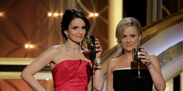 BEVERLY HILLS, CA - JANUARY 12: In this handout photo provided by NBCUniversal, Hosts Tina Fey and Amy Poehler speak onstage during the 71st Annual Golden Globe Award at The Beverly Hilton Hotel on January 12, 2014 in Beverly Hills, California. (Photo by Paul Drinkwater/NBCUniversal via Getty Images)
