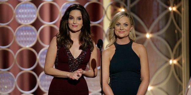 BEVERLY HILLS, CA - JANUARY 12: In this handout photo provided by NBCUniversal, Hosts Tina Fey and Amy Poehler speak onstage during the 71st Annual Golden Globe Award at The Beverly Hilton Hotel on January 12, 2014 in Beverly Hills, California. (Photo by Paul Drinkwater/NBCUniversal via Getty Images)