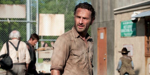 In this publicity photo provided by AMC, actor, Andrew Lincoln, as Rick Grimes, center, is shown in a scene from AMC's "The Walking Dead," Season 3, Episode 1. (AP Photo/AMC, Gene Page)