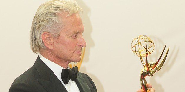 Michael Douglas celebrates winning Best Actor in a Miniseries/Movie for playing Liberace in 'Behind the Candelabra' on September 22, 2013 in the press room during the 65th Annual Primetime Emmy Awards in Los Angeles, California. AFP PHOTO/Frederic J. BROWN (Photo credit should read FREDERIC J. BROWN/AFP/Getty Images)