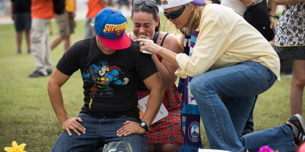 ORLANDO, FL - JUNE 13: (L to R) Jimaida Arrieta and Jessica Ellison cry at a makeshift memorial prior to an evening vigil for the victims of the Pulse Nightclub shootings, at the Dr. Phillips Center for the Performing Arts, June 13, 2016 in Orlando, Florida. The shooting at Pulse Nightclub, which killed 49 people and injured 53, is the worst mass-shooting event in American history. (Photo by Drew Angerer/Getty Images)