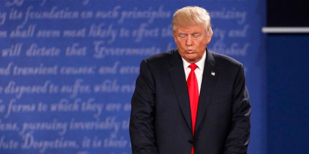 Republican U.S. presidential nominee Donald Trump listens as Democratic U.S. presidential nominee Hillary Clinton (not pictur