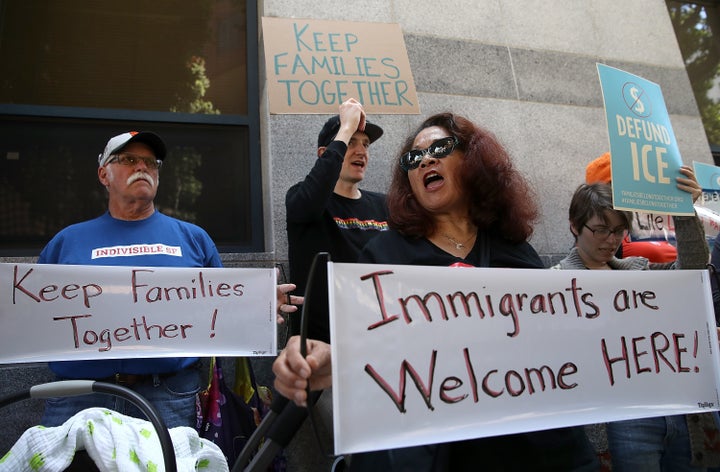 Protesters hold signs during a demonstration outside of the San Francisco office of the Immigration and Cutsoms Enforcement i