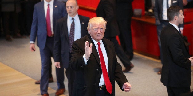 NEW YORK, NY - NOVEMBER 22: President-elect Donald Trump walks through the lobby of the New York Times following a meeting with editors at the paper on November 22, 2016 in New York City. Trump, who has held meetings with media executives over the last few days, has often had a tense relationship with many mainstream media outlets. (Photo by Spencer Platt/Getty Images)