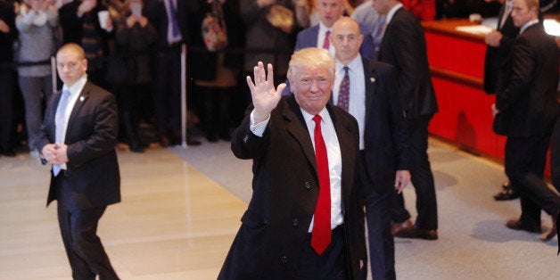 U.S. President elect Donald Trump reacts to a crowd gathered in the lobby of the New York Times building after a meeting in New York, U.S., November 22, 2016. REUTERS/Lucas Jackson 