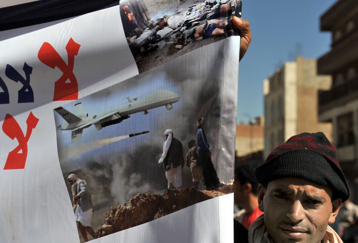 A Yemeni hold up a banner during a protest against US drone attacks on Yemen close to the home of Yemeni President Abdrabuh Mansur Hadi, in the capital Sanaa, on January 28, 2013. Strikes by US drones in Yemen nearly tripled in 2012 compared to 2011, with 53 recorded against 18, according to the Washington-based think-tank New America Foundation. AFP PHOTO/STR (Photo credit should read -/AFP/Getty Images)