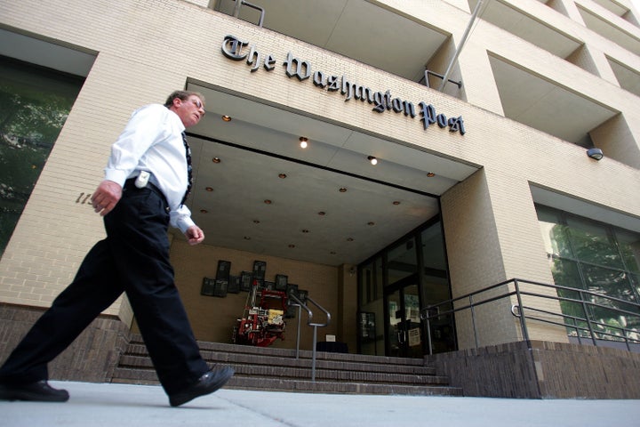 WASHINGTON - MAY 31: A man walks past the Washington Post building May 31, 2005 in Washington, DC. A Vanity Fair magazine art