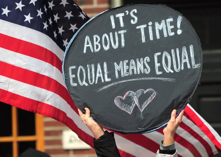 Marriage equality supporters take part in a march and rally ahead of US Supreme Court arguments on legalizing same-sex marria