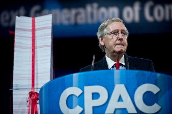 US Senate Minority Leader Mitch McConnell speaks next to a stack of papers representing what he claimed to be the regulations
