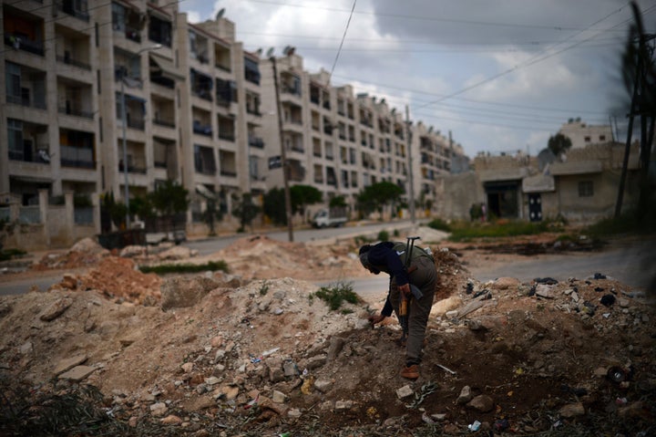 A Syrian rebel patrols the area in the Sheikh Maqsud district of the northern Syrian city of Aleppo, on April 11, 2013. G8 foreign ministers meeting in London said they were 'appalled' by the rising death toll of more than 70,000 in the Syrian conflict and urged all countries to boost aid to a UN appeal for the country. AFP PHOTO / DIMITAR DILKOFF (Photo credit should read DIMITAR DILKOFF/AFP/Getty Images)