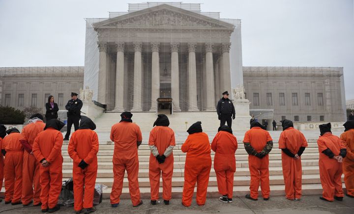 Hooded demonstrators take part in a rally to call for the closing of the Guantanamo Bay detention center on January 11, 2013 in front of the US Supreme Court on Capitol Hill in Washington. AFP PHOTO/Mandel NGAN (Photo credit should read MANDEL NGAN/AFP/Getty Images)