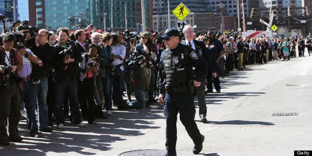 BOSTON - APRIL 17: A large crowd of media and onlookers formed outside the Moakley Federal Courthouse initially on reports that a suspect in the Marathon bombings had been arrested. Later, a bomb threat caused the evacuation of all inside the courthouse. (Photo by Barry Chin/The Boston Globe via Getty Images)