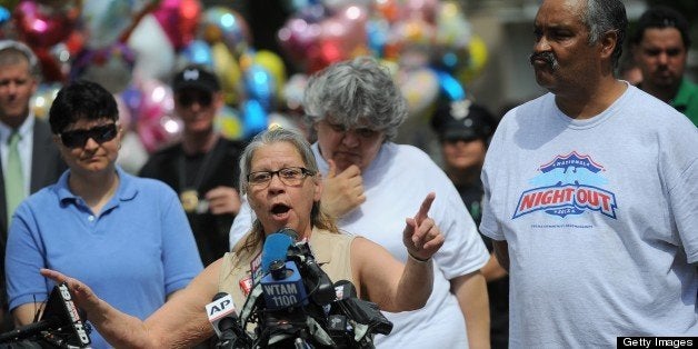 Gina DeJesus's parents Nancy and Felix (R) talk to the press after their daughter arrived at her family home on May 8, 2013 in Cleveland, Ohio. DeJesus along with two other women were rescued this week after a decade spent imprisoned and tormented in a kidnapper's house made an emotional return to their families on Wednesday. AFP PHOTO/Emmanuel Dunand (Photo credit should read EMMANUEL DUNAND/AFP/Getty Images)