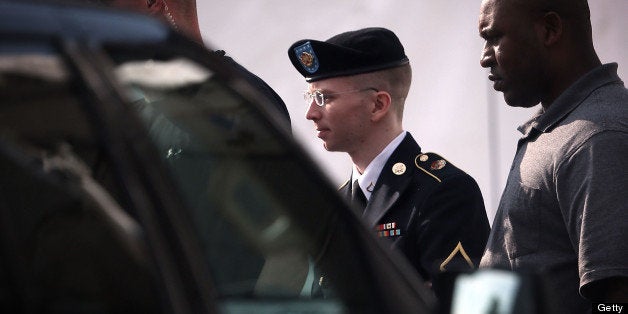 FORT MEADE, MD - JUNE 03: U.S. Army Private First Class Bradley Manning (C) is escorted as he leaves a military court for th