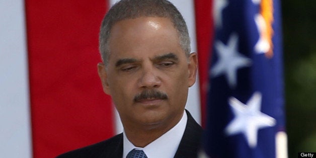 ARLINGTON, VA - JUNE 05: Attorney General Eric Holder participates in a ceremony to honor civil rights pioneer Medgar Evers at an Arlington National Cemetery, June 5, 013 in Arlington, Virginia. The event was held to commemorate the life of the World War II veteran who is buried at Arlington. (Photo by Mark Wilson/Getty Images)
