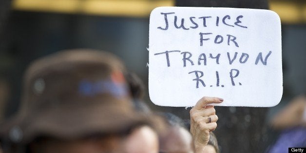 Demonstrators angry at the acquittal of George Zimmerman in the death of Trayvon Martin protest in Los Angeles, California July 14, 2013. Thousands protested in US cities overnight as President Barack Obama appealed for calm following the acquittal in Florida of a man who gunned down an unarmed black teenager. The angry protests highlight simmering racial tensions after a jury found volunteer watchman George Zimmerman not guilty of murdering 17 year-old Trayvon Martin. Demonstrators held noisy rallies in US cities including New York, San Francisco, Boston, Detroit and Chicago. At least six people were arrested in Los Angeles early Monday when riot police broke up an 'unlawful assembly' in Hollywood near the CNN building.AFP PHOTO / ROBYN BECK (Photo credit should read ROBYN BECK/AFP/Getty Images)