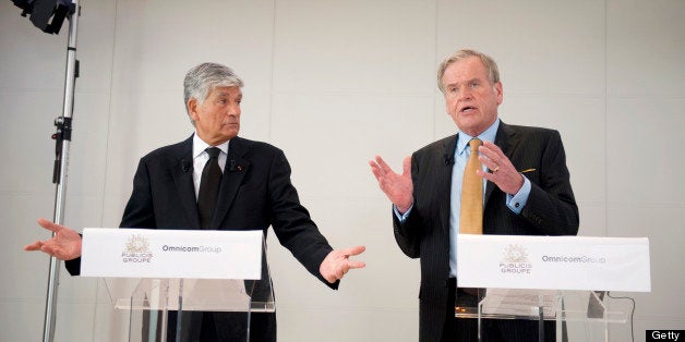 Maurice Levy, chief executive officer of Publicis Groupe SA, left, and John Wren, chief executive officer of Omnicom Group Inc., speak on the merger of the two companies during a news conference at the Publicis headquarters in Paris, France, on Sunday, July 28, 2013. Publicis Groupe SA and Omnicom Group Inc. agreed to merge in an all-stock transaction to create the world's largest advertising company with $23 billion in revenue, toppling market leader WPP Plc. Photographer: Balint Porneczi/Bloomberg via Getty Images 