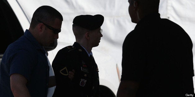 FORT MEADE, MD - JULY 30: U.S. Army Private First Class Bradley Manning (c) is escorted by military police as arrives to hea