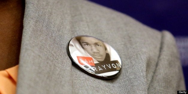 The parents of Trayvon Martin, Sybrina Fulton and Tracy Martin, don buttons with the face of their slain son, during a news c