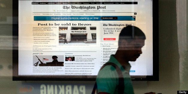 WASHINGTON, DC - AUGUST 05: A man leaves the Washington Post building after the announced sale of the newspaper August 5, 2013 in Washington, DC. The Graham family has agreed to sell the flagship newspaper for $250 million to Amazon.com founder Jeff Bezos. (Photo by Win McNamee/Getty Images)
