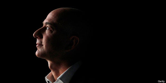 FILE PHOTO: 'BEST PHOTOS OF 2012' (***BESTOF2012***): Jeff Bezos, chief executive officer of Amazon.com Inc., watches a video of the new Kindle Fire HD tablet at a news conference in Santa Monica, California, U.S., on Thursday, Sept. 6, 2012. Amazon.com Inc. is updating its line of Kindle e-readers and tablets in a bid to stoke consumer demand as Google Inc. and Microsoft Corp. join the crowded market of machines challenging Apple Inc.'s iPad. Photographer: Patrick Fallon/Bloomberg via Getty Images 