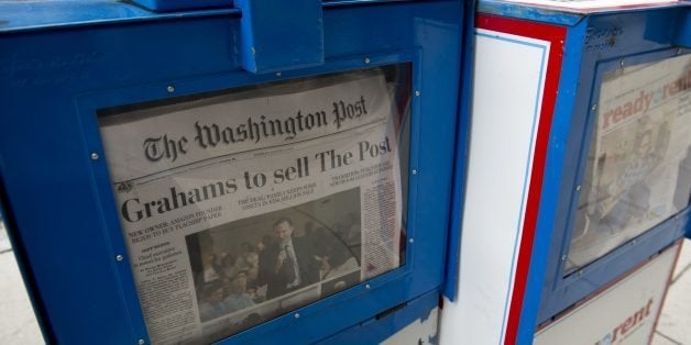 The front page of the Washington Post newspaper as seen in a newstand, August 6, 2013 in Washington, DC, the day after it was announced that Amazon.com founder and CEO Jeff Bezos had agreed to purchase the newspaper for USD 250 million from the Graham family. Multi-billionaire Bezos, who created Amazon, which has soared in a few years to a dominant position in online retailing, said he was buying the Post in his personal capacity and hoped to shepherd it through the evolution away from traditional newsprint. AFP PHOTO / Saul LOEB (Photo credit should read SAUL LOEB/AFP/Getty Images)