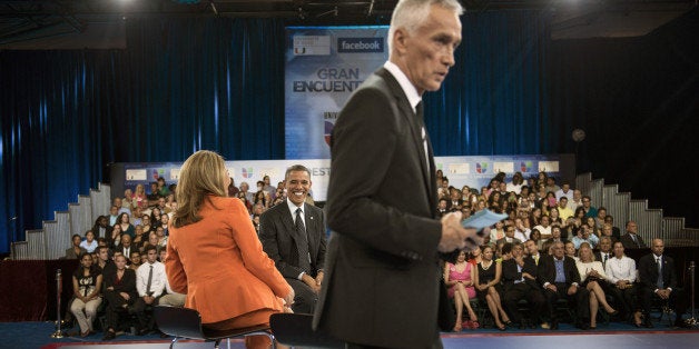 US President Barack Obama (C) talks with co-host Maria Elena Salinas (L) as co-host Jorge Ramos looks over papers during a break in a taping of Univision News's 'Meet the Candidates' at the University of Miami September 20, 2012 in Coral Gables, Florida. Obama is traveling to Florida for the day to participate in a taping for Univision in Miami before attending a campaign event in Tampa. AFP PHOTO/Brendan SMIALOWSKI (Photo credit should read BRENDAN SMIALOWSKI/AFP/GettyImages)