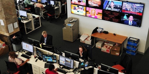 Journalists work in the main newsroom area of the new Al Jazeera America television broadcast studio on West 34th Street Augu